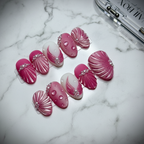 Pink Shell 3D Press-On Nails full set on marble surface, 45 degree angle