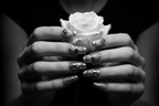 Fair-skin hands wearing gothic silver chrome custom press-on nails holding white silver-tipped rose — LuxepressCo