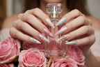 Lifestyle light skin hands wearing romantic angel custom press-on nails holding pink roses — LuxepressCo