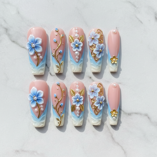 Flat lay top-down 10 blue floral pearl gold vine custom press-on nails white marble — LuxepressCo