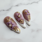 Close-up glossy texture 3D floral baroque press-on nails purple gold marble background — LuxepressCo