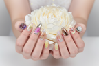 Fair-skin hands wearing aurora fantasy mermaid custom press-on nails holding iridescent white-gold peony — LuxepressCo