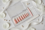 Luxury acrylic box unboxing nude blush pearl rhinestone French tip almond custom press-on nails with accessories — LuxepressCo