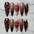 Full set 10 burgundy gold floral foil custom press-on nails on marble background — LuxepressCo