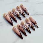 Hero studio shot full set 10 burgundy ombre 3D orchid stiletto custom press-on nails white marble — LuxepressCo