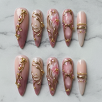 Flat lay top-down full set 10 luxury 3D gold filigree pink floral stiletto custom press-on nails white marble — LuxepressCo