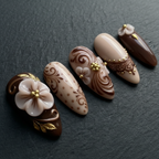 Close-up macro 3D white porcelain flower gold leaf chocolate brown custom press-on nails dramatic lighting — LuxepressCo