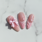 Close-up macro satin ribbon bow coquette custom press-on nails pink pearl detail marble background — LuxepressCo
