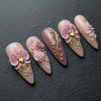 Macro close-up 3D orchid rose gold filigree rhinestone custom press-on nails dramatic lighting — LuxepressCo