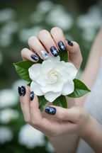 Midnight galaxy custom press-on nails lifestyle light skin 10 fingers holding white flower — LuxepressCo