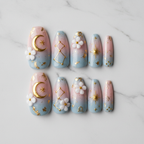Flat lay top-down full set 10 celestial floral custom press-on nails white marble background — LuxepressCo