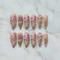 Flat lay top-down full set 10 custom press-on nails 3D pink floral gold pearl rhinestone — LuxepressCo