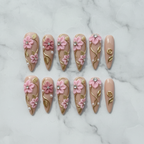 Flat lay top-down full set 10 custom press-on nails 3D pink floral gold pearl rhinestone — LuxepressCo
