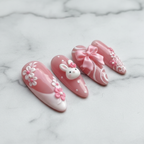 Macro close-up white lace filigree and pink floral 3D press-on nails marble background salon-quality nails — LuxepressCo