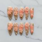 Flat lay top-down full set 10 3D rose gold filigree peach coral custom press-on nails overhead studio — LuxepressCo