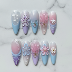 Flat lay top-down full set 10 mermaid 3D press-on nails pastel blue lavender pink marble background — LuxepressCo
