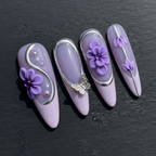 Macro close-up 3D purple flower butterfly charm pearl bead custom press-on nails dramatic lighting — LuxepressCo