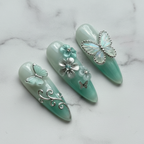 Close-up silver vine swirl 3D flower mint green salon-quality press-on nails marble background — LuxepressCo