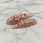Close-up texture gloss 3D floral gold vine pearl stiletto salon-quality nails marble — LuxepressCo