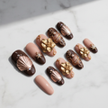 Chocolate brown rose gold chrome fan shell 3D magnolia custom press-on nails gold vine star charm full set flat lay — LuxepressCo