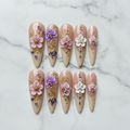 Flat lay top-down full set 10 3D floral orchid crystal stiletto custom press-on nails white marble — LuxepressCo