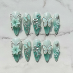 Flat lay top-down full set 10 mint aurora 3D flower silver butterfly salon-quality nails white marble — LuxepressCo