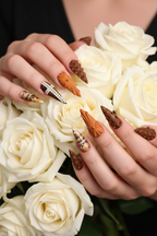 Light skin hands with gothic rhinestone cross caramel stiletto reusable nails holding roses — LuxepressCo