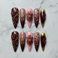 Flat lay top-down full set 10 burgundy gold floral foil custom press-on nails — LuxepressCo