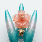 Macro close-up aqua teal aurora pearl 3D hibiscus gold sea turtle charm salon-quality stiletto press-on nails — LuxepressCo