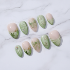 Matcha garden gold wire butterfly bow daisy custom press-on nails sage green ombre French tip clover charm full set flat lay — LuxepressCo