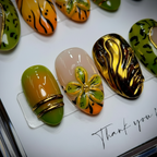 Macro close-up orange green gradient gold chrome 3D flower wild print salon-quality nails detail — LuxepressCo