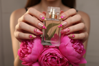 Lifestyle light skin hands wearing hot pink gold bubble gem custom press-on nails holding pink peonies — LuxepressCo