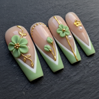 Macro close-up sage green 3D clay flower press-on nails gold vine pearl detail dark background — LuxepressCo