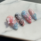 Close-up butterfly wing nail art white marble texture salon-quality nails glossy finish — LuxepressCo