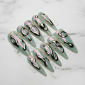Aurora chrome 3D liquid metal stiletto press-on nails full set on white marble studio — LuxepressCo