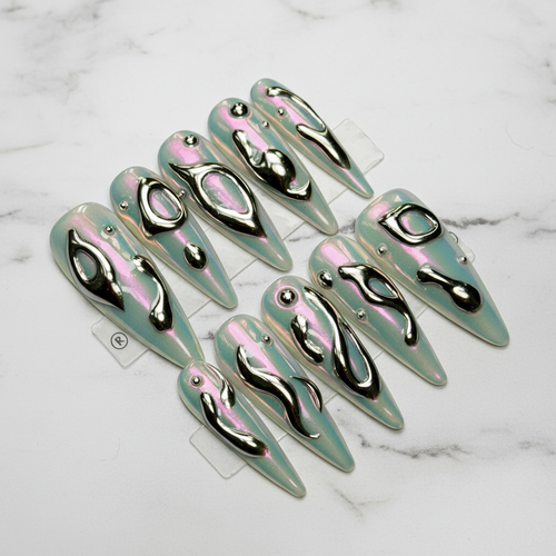 Aurora chrome 3D liquid metal stiletto press-on nails full set on white marble studio — LuxepressCo