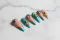 Hero studio shot full set 10 teal gold 3D floral stiletto custom press-on nails white marble — LuxepressCo