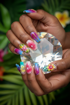 Dark skin hands wearing rainbow aurora tropical square custom press-on nails holding rainbow crystal prism — LuxepressCo