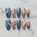Flat lay top-down full set 10 blue marble gold butterfly floral custom press-on nails — LuxepressCo