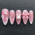 Close-up macro 3D white bunny charm and pink bow press-on nails dramatic lighting custom press-on nails — LuxepressCo