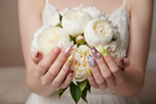 Fair-skin hands wearing holographic star chrome custom press-on nails holding flowers — LuxepressCo