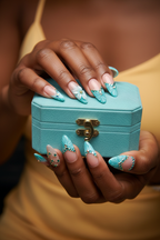 Dark skin hands wearing teal 3D floral rhinestone custom press-on nails holding turquoise jewelry box — LuxepressCo