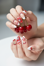Fair skin hands wearing cherry blood orange ruby rhinestone custom press-on nails holding fresh red cherries — LuxepressCo