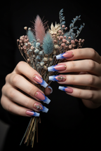 Fair-skin lifestyle dusty rose blue flame tip crystal cross custom press-on nails holding dried flowers — LuxepressCo