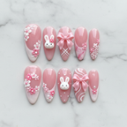 Flat lay top-down full set 10 3D bunny bow floral coquette salon-quality nails white marble — LuxepressCo