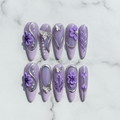 Flat lay top-down full set 10 purple butterfly floral custom press-on nails white marble studio — LuxepressCo