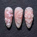 Close-up 3D sculpted flower pearl butterfly crystal charm custom press-on nails blush pink — LuxepressCo