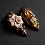 Macro close-up 3D ivory flower amber resin panels custom press-on nails tortoiseshell dark brown gold — LuxepressCo