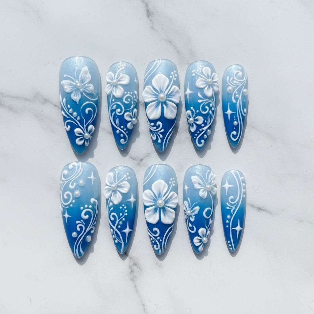 Flat lay top-down full set 10 blue ombre 3D floral pearl custom press-on nails overhead studio — LuxepressCo