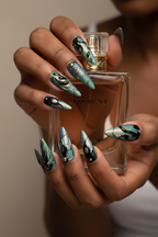 Dark skin hands with beetle wing chrome reusable nails holding perfume bottle — LuxepressCo